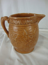Load image into Gallery viewer, Early Unmarked McCoy Orange Stoneware Water Lily Pitcher with Fish Handle