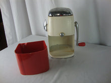 Load image into Gallery viewer, MCM retro Ice O Mat hand crank ice crusher with cream and red metal and plastic body with chrome flip top lid and handle. Crusher has wear/tear, finish loss, scratches, stains and measures about 8" height by 5" width by 4" depth.