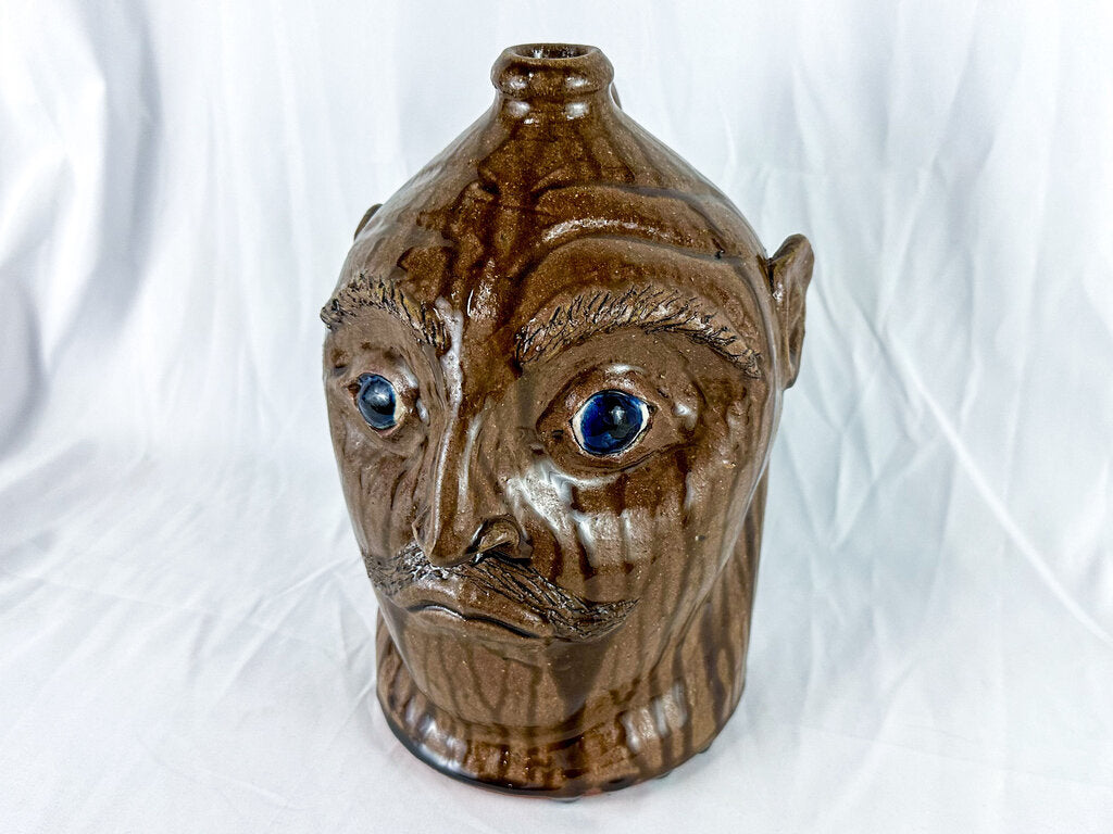 Large Mike Craven Signed Brown Ugly Face Jug with Big Round Blue Eyes