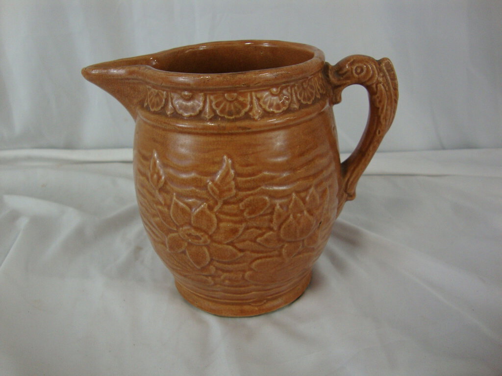 Early Unmarked McCoy Orange Stoneware Water Lily Pitcher with Fish Handle