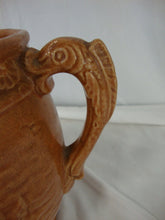 Load image into Gallery viewer, Early Unmarked McCoy Orange Stoneware Water Lily Pitcher with Fish Handle
