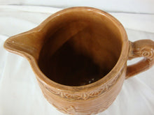 Load image into Gallery viewer, Early Unmarked McCoy Orange Stoneware Water Lily Pitcher with Fish Handle
