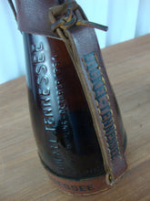 Load image into Gallery viewer, 1984 George Dickel Tennessee Whiskey Brown Glass Souvenir Bottle with Leather Harness Empty
