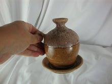 Load image into Gallery viewer, 1987 John Garrou Old Fort Pottery Tan Drip Glaze Small Finger Loop Jar with Attached Plate

