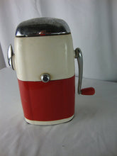 Load image into Gallery viewer, MCM retro Ice O Mat hand crank ice crusher with cream and red metal and plastic body with chrome flip top lid and handle. Crusher has wear/tear, finish loss, scratches, stains and measures about 8" height by 5" width by 4" depth.
