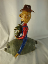 Load image into Gallery viewer, Marvin Bailey Artist Signed Cowboy Farmer with Mini Ugly Face Jug on Green Specked Pig Stack
