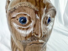 Load image into Gallery viewer, Large Mike Craven Signed Brown Ugly Face Jug with Big Round Blue Eyes
