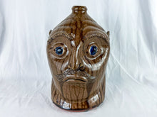 Load image into Gallery viewer, Large Mike Craven Signed Brown Ugly Face Jug with Big Round Blue Eyes
