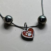 Load image into Gallery viewer, Necklace with Pendant, Sterling Silver, Orange Enamel with Pawprint, Two Flanking Beads
